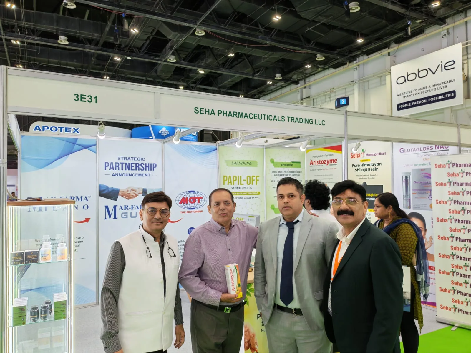 Four people standing together in front of a pharmaceutical exhibition stand at DUPHAT 2026, Dubai