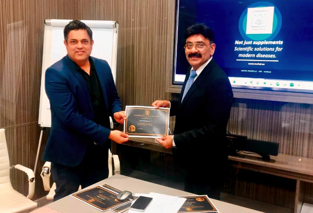 Mohammed Shakeel Hashmi presenting a certificate of consultation to a partner at the RAUFSAL office