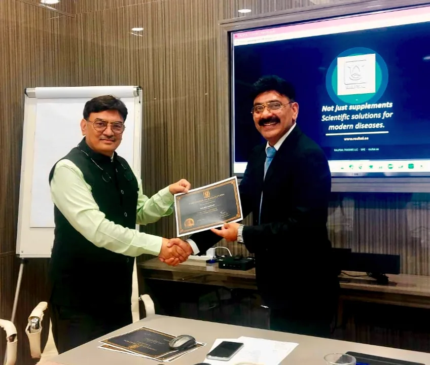 Mohammed Shakeel Hashmi presenting a certificate to a consultation partner at the RAUFSAL office