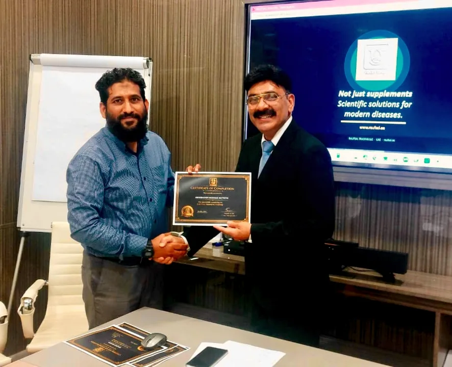 Mohammed Shakeel Hashmi presenting a certificate of completion after a nutrition training programme