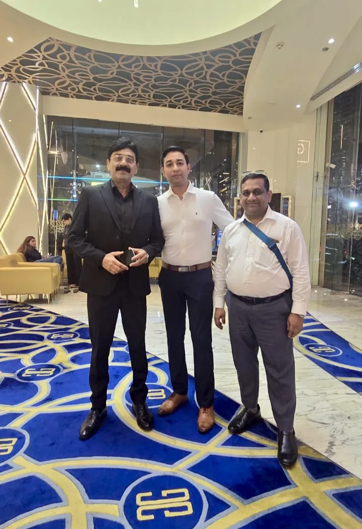 Three people standing together in a hotel lobby