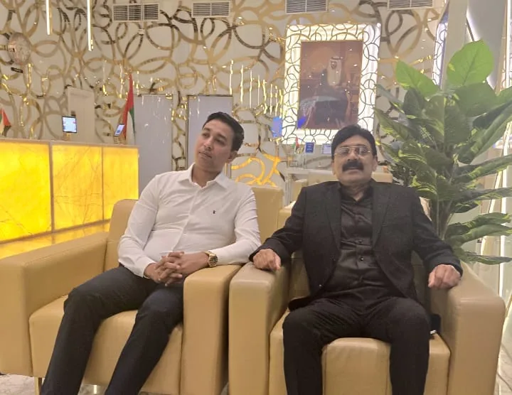 Two people seated side by side in a hotel lounge